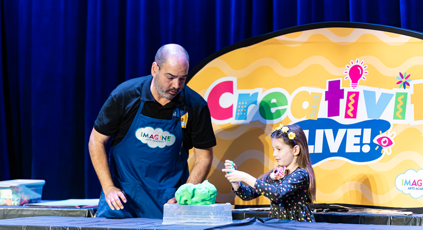 Instructor and child on stage during Creativity Live event
